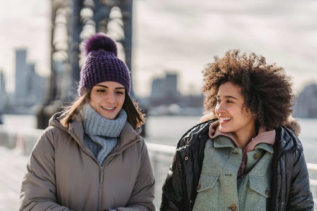 Two women walking in snow