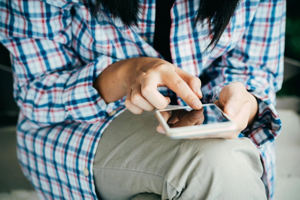 close up of woman scrolling smart phone