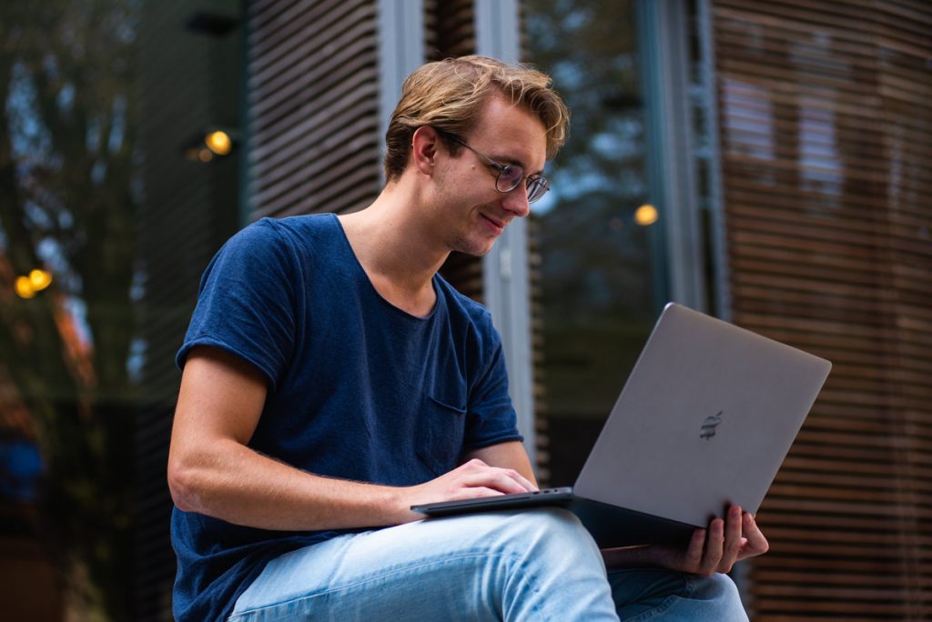 smiling man on laptop