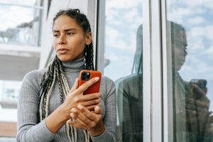 worried woman with smartphone