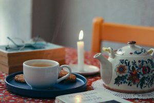 candle, book, and tea