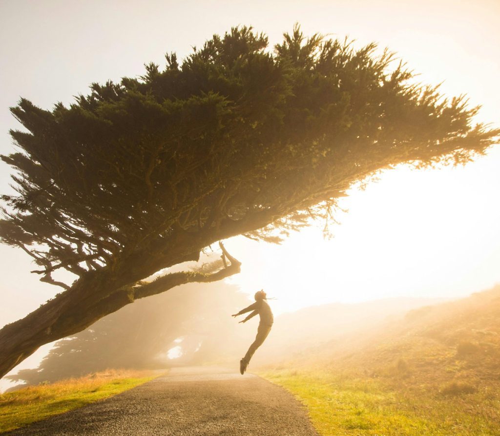 dreamy image of person flying into sunrise