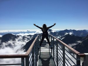 triumphant person above the clouds.