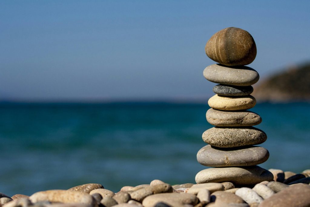 pile of rocks on placid water