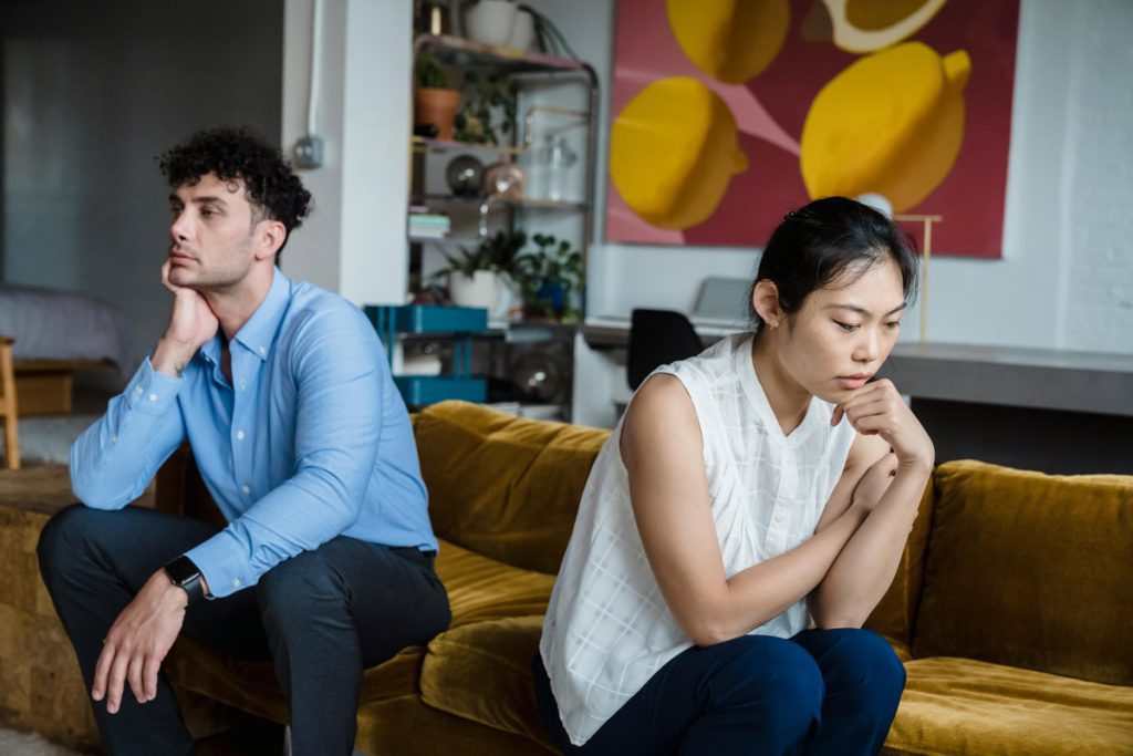 unhappy couple on couch