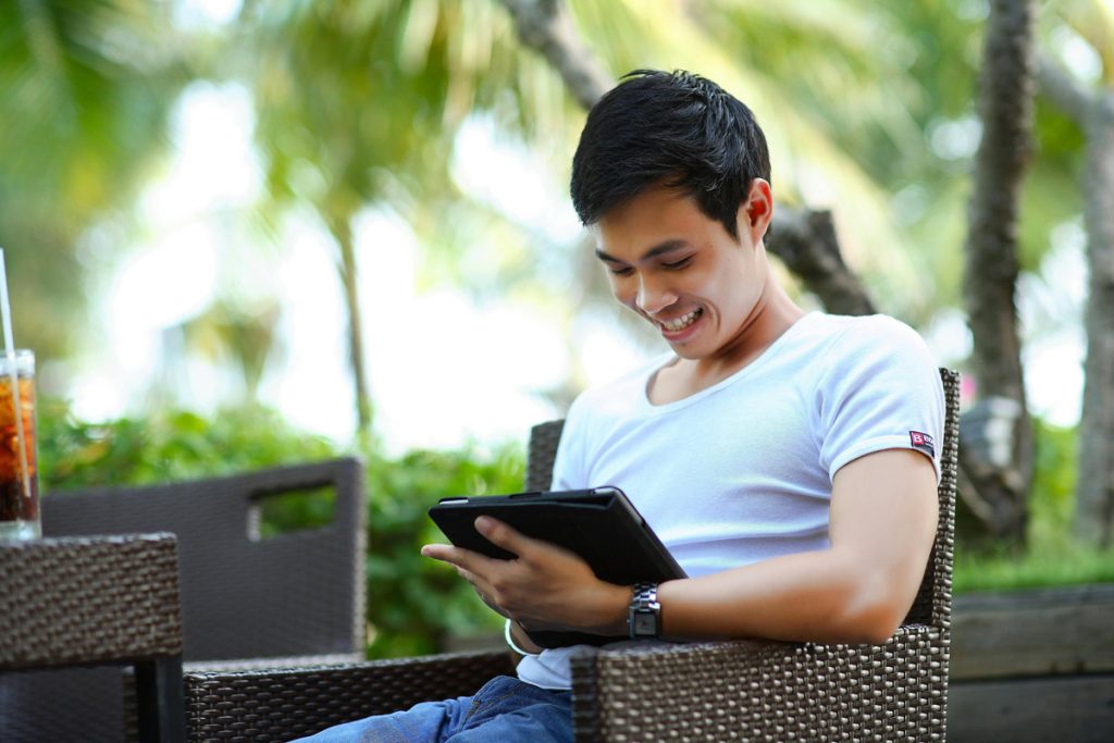 man using tablet outside