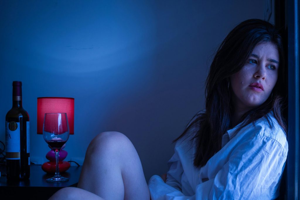 sad woman drinking wine