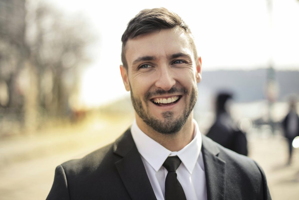 Smiling man in suit and tie.