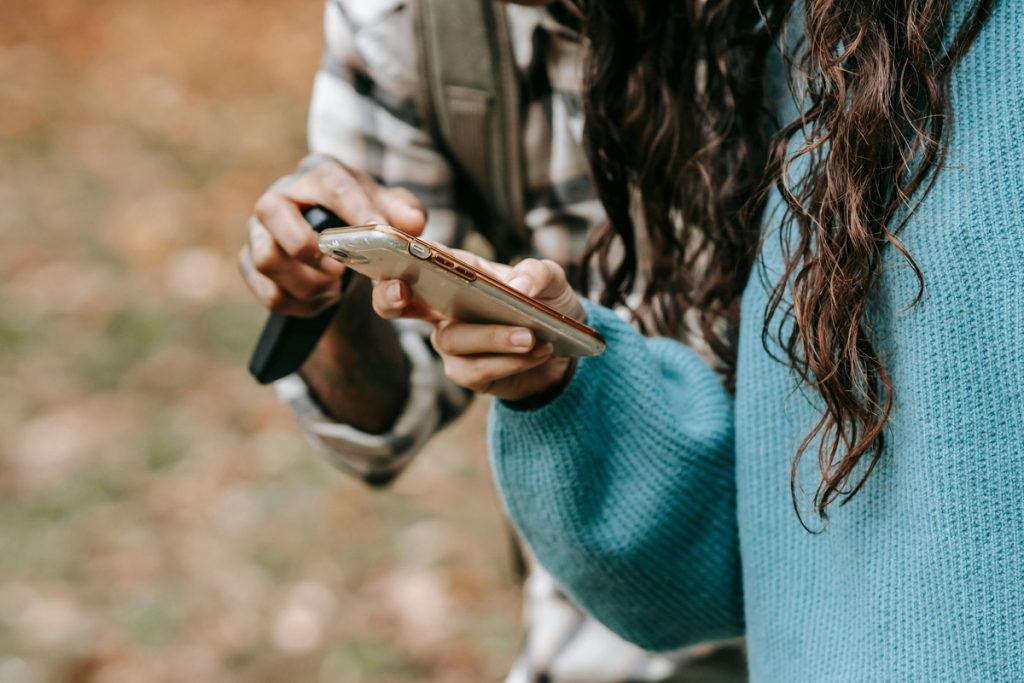 Close up of friends pointing to smartphone screen