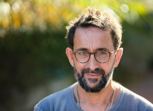 content man with glasses in blue t-shirt