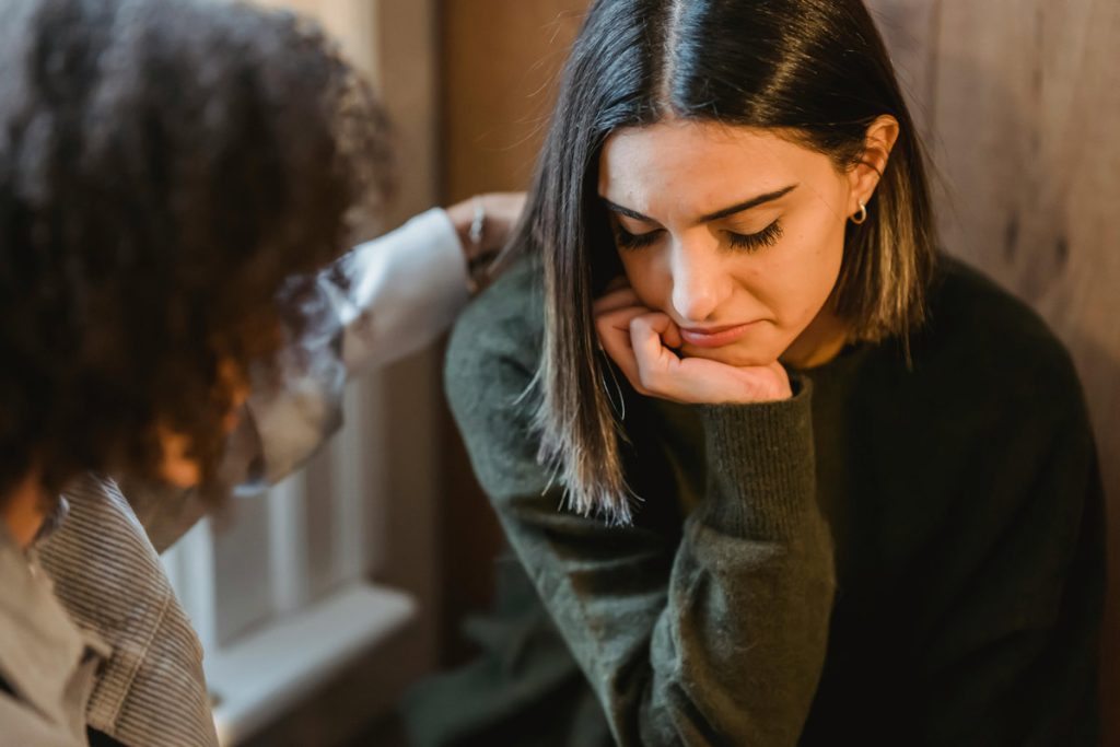 Woman receiving comfort during a difficult moment.