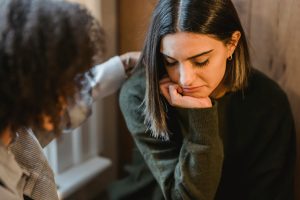 Woman receiving comfort during a difficult moment.