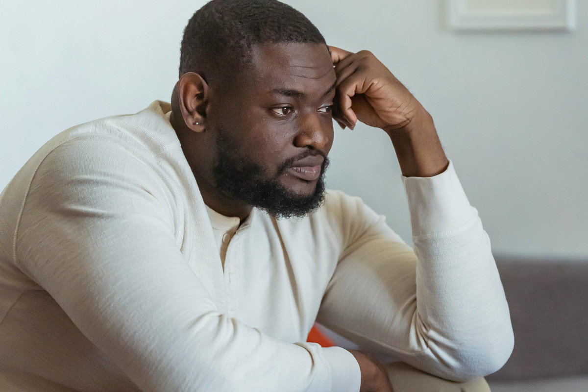 Man deep in thought, appearing concerned or reflective.
