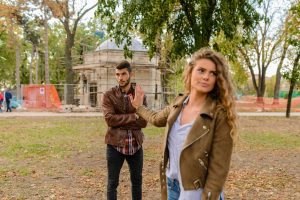 Couple standing outside experiencing emotional conflict and distance.