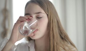 Woman closing her eyes and drinking a