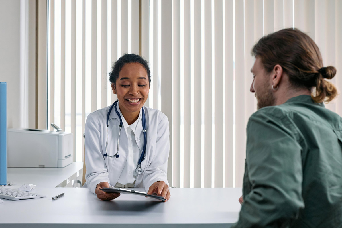 Healthcare provider consulting with patient about addiction treatment options in a bright, welcoming medical office.