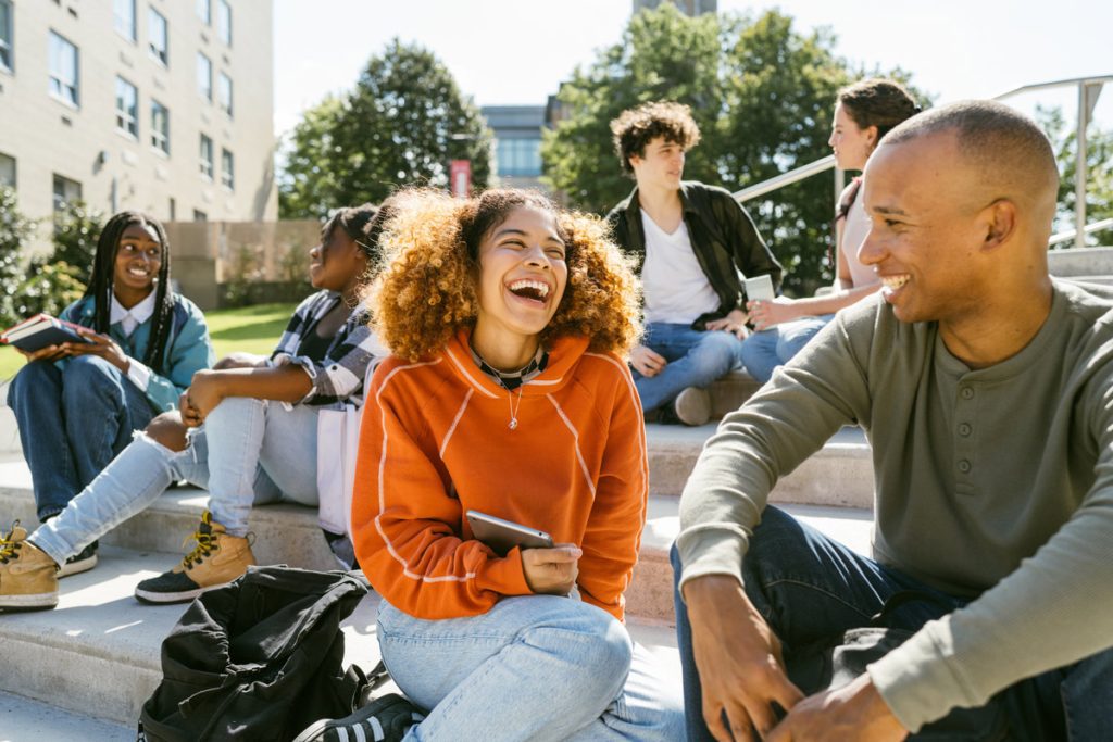 Two friends laughing together showing authentic joy and emotional connection through laughter