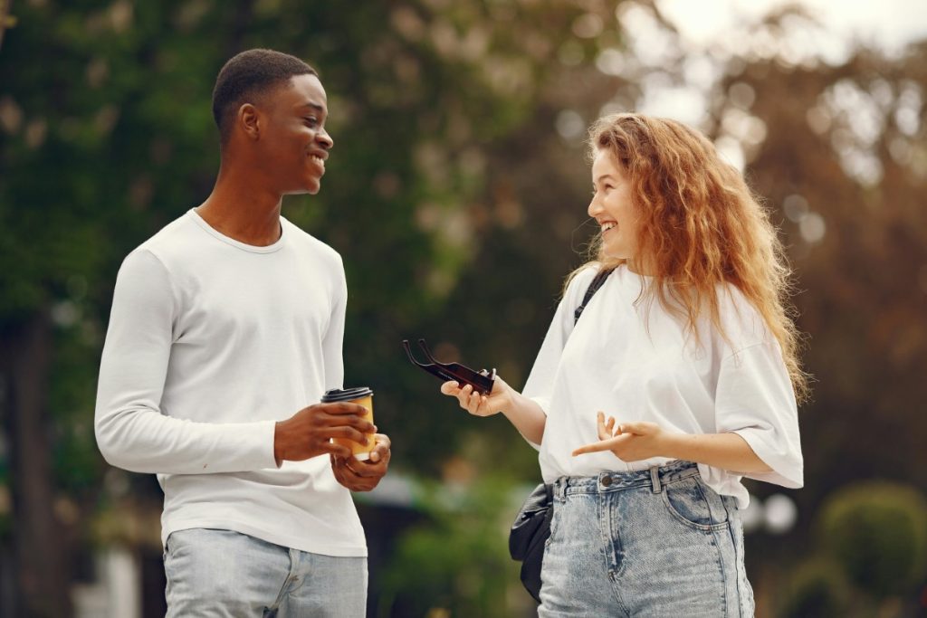A man and a woman smiling at each other, reflecting the connection between mental wellness and stronger relationships.