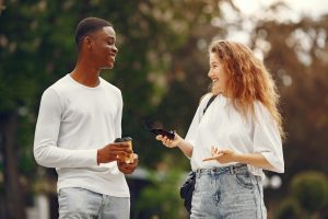 A man and a woman smiling at each other, reflecting the connection between mental wellness and stronger relationships.
