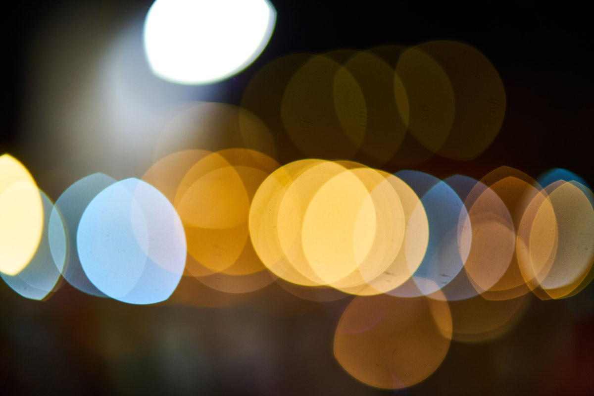 Abstract bokeh image of layered orange and blue circles.
