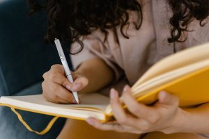 close up of a woman writing in a journal